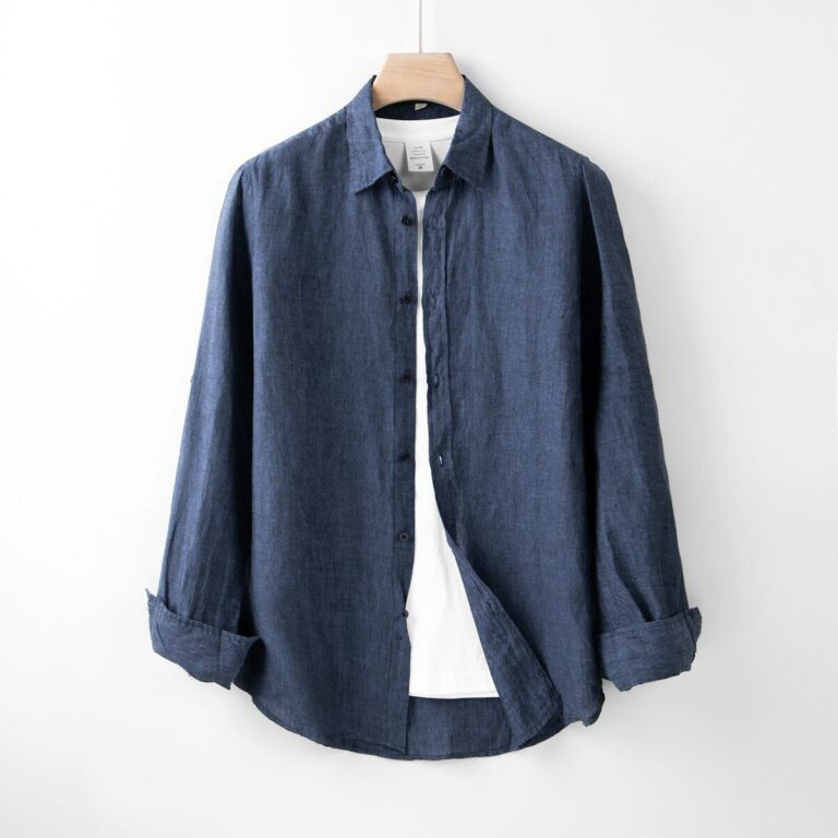 A blue shirt hanging on a white wall