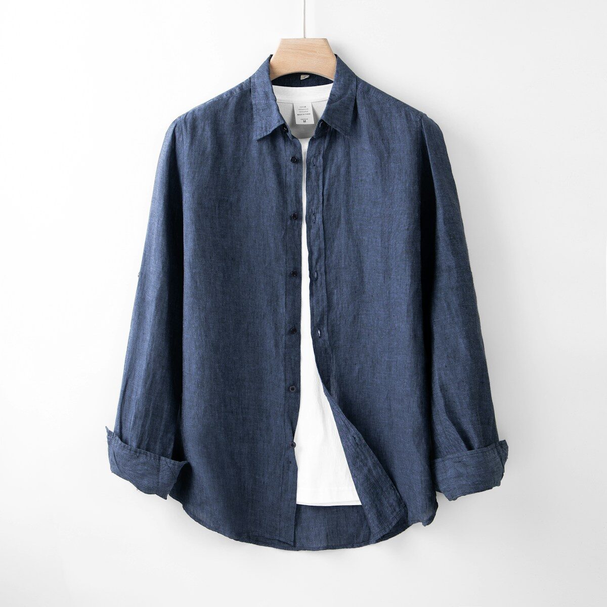 Photo by Robert Richman A blue shirt hanging on a white wall